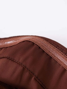 Detail view of anti-slip silicone strip on deep brown velvet strapless corset top