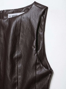 Detailed macro shot of the dark brown leather texture and zipper on the sleeveless top
