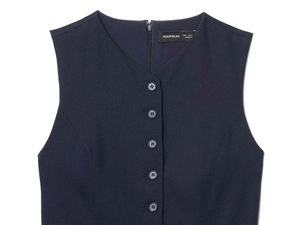 Detail view of the V-neckline and row of buttons on the dark blue sleeveless vest dress
