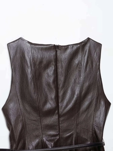 Detailed view of dark brown leather top with belt showing high quality material texture