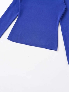 Detailed macro view of royal blue knit fabric texture and smooth edge stitching