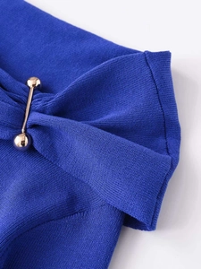 Detail of royal blue knit top with gold metal barbell hardware and premium texture