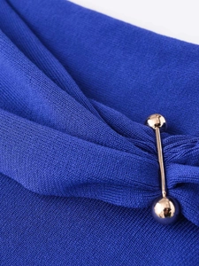 Detailed close-up of blue knit fabric texture with a decorative gold metal ball bar