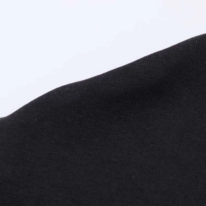 Close-up of premium black high-density knit fabric texture for short summer dress