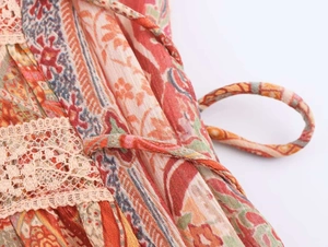 Detail of paisley print fabric with crochet lace trim and matching drawstring tie