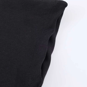 Detailed macro view of black knit fabric texture and high-quality flat seam stitching