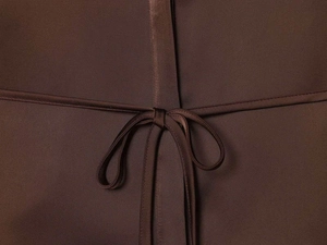 Detailed view of dark brown satin shirt with a smooth fabric texture and tied waist belt