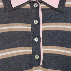 Women's striped knit polo sweater with pink contrast collar and pearl button details