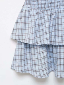 Detail view of light blue checkered tiered skirt with elastic pleats and woven texture