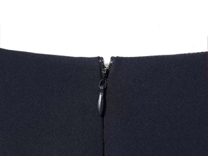 Detailed close-up of a high-quality invisible zipper on a black sleeveless summer dress
