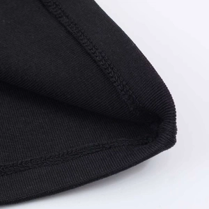Close-up of black knitted fabric showing fine double-needle stitching and ribbed hem texture
