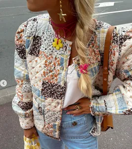 Detailed street style shot of patchwork quilted jacket with floral patterns and buttons