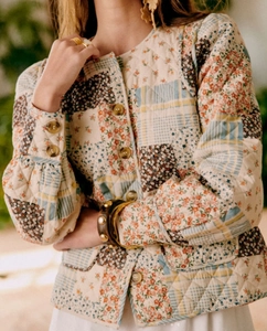 Close-up of quilted patchwork jacket detail with floral patterns and diamond stitching