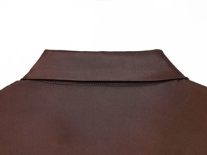 Detail of a chocolate brown satin shirt collar with precise stitching and fine texture