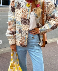 Detail shot of the floral patchwork quilted jacket and embroidered white camisole