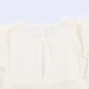 Detail of ruffled round neckline with keyhole opening on off-white chiffon blouse