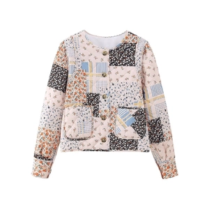 Detailed view of quilted cotton jacket with floral patchwork and amber buttons