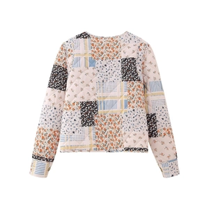 Detail of quilted long-sleeved jacket featuring unique floral patchwork patterns