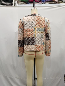 Detailed back view of patchwork quilted jacket with floral prints and diamond stitching