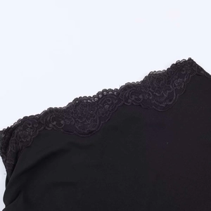 Close-up of elegant black lace floral embroidery stitched onto premium knit dress fabric