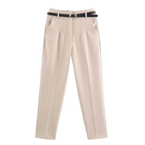 Detail of high-waisted beige trousers with front pleats and a slim black belt