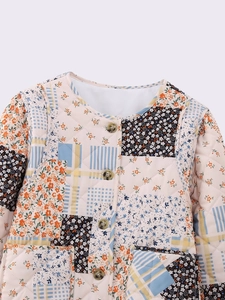 Close-up of diamond quilting and vintage patchwork floral patterns on cotton jacket
