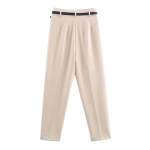 Detail of high-waisted beige trousers with crisp pleats and a slim black belt for women