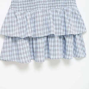 Short sleeve A-line summer dress with blue plaid pattern and tiered ruffle details
