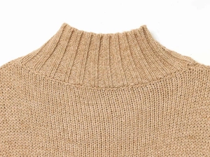 Detailed macro view of the camel knit top showing its ribbed high-neck and thick texture