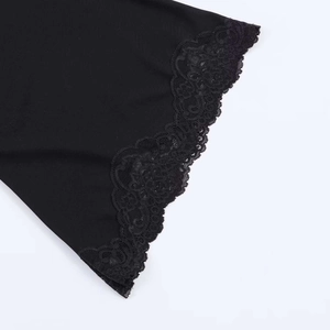 Close-up of intricate floral black lace trim on a stylish minimalist summer dress
