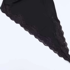 Close-up detail of the intricate floral lace trim on a stylish black summer dress