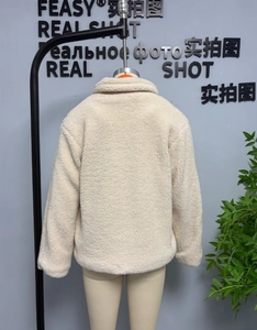 Back view of a beige oversized faux fur coat featuring a soft texture and drop shoulder design