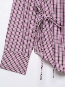 Detail of pink plaid shirt with side drawstring ties and wide cuff design details