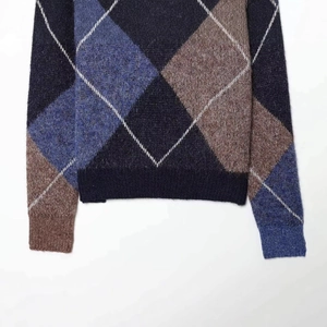 Retro argyle knit sweater with navy and brown diamond pattern and ribbed cuffs