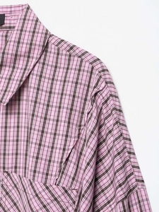Close-up of pink and brown plaid pattern fabric texture and collar detail on shirt