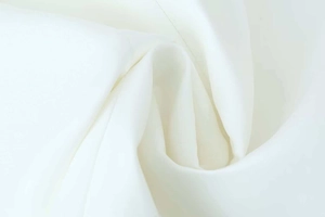 Close-up of premium white silky fabric showing soft texture and natural subtle sheen