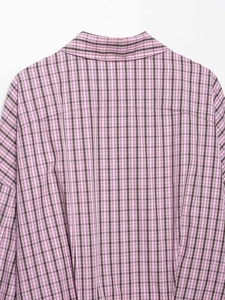 Detail of pink and black plaid shirt showing back neckline and shoulder seam textures