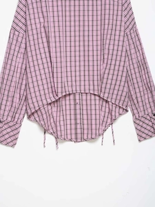 Detailed view of the plaid shirt with adjustable side drawstring and asymmetric hemline