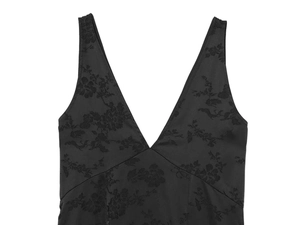 Close-up of black satin jacquard fabric with floral patterns and a deep V-neckline