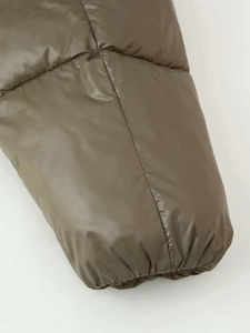 Detail of olive green puffer jacket sleeve with elastic cuff and quilted windproof fabric