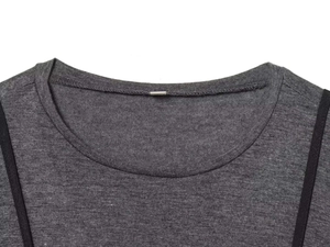 Detailed neckline of dark grey knit top with refined binding and rectangular silver tag