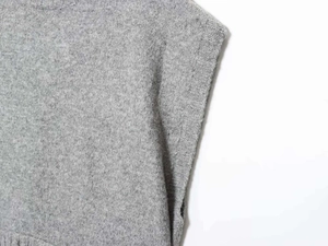 Close-up of gray knitted tank top showing premium wool texture and ribbed crew neck finish