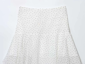 Close-up of white polka dot chiffon skirt with mesh layers and horizontal stitching