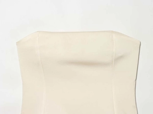 Detail of cream strapless top showing symmetrical princess seams and smooth fabric texture