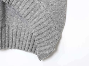 Close-up of the grey ribbed knit hem and soft wool texture of the sleeveless tank top