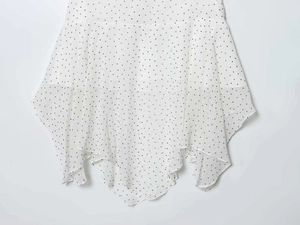 Detail of white chiffon skirt with black polka dots and layered handkerchief hemline