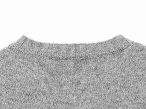 Close-up of the ribbed crew neck detail on this slim fit light grey knitted vest