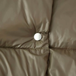 Olive green quilted puffer jacket featuring a stand collar and silver metal snap button