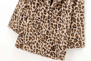 Close-up of leopard print faux fur coat featuring soft texture and functional side pocket