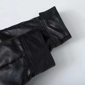 Detailed close-up showing the fine texture and double stitching on black leather jacket